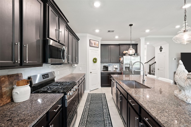 3447 Warwick River Trl, Kingwood, TX 77365 - kitchen with stainless steel appliances, decorative backsplash, light tile patterned flooring, dark stone counters, and ornamental molding