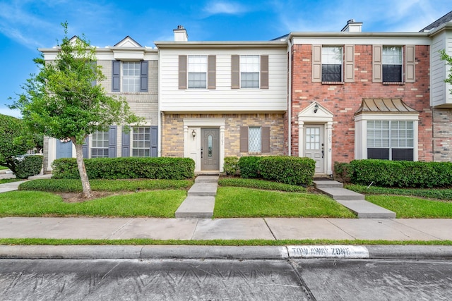 2910 Grants Lake Blvd Unit 1702, Sugar Land, TX 77479 - view of property featuring a chimney and brick siding