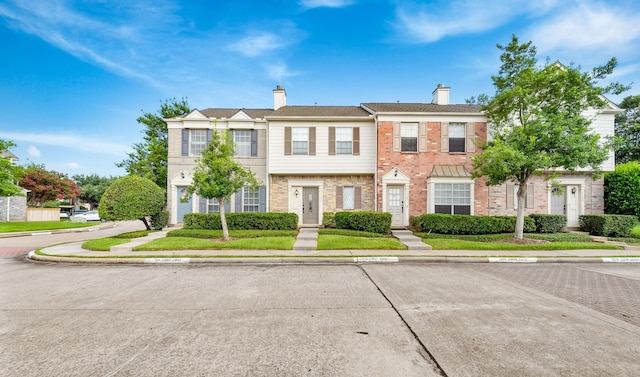 2910 Grants Lake Blvd Unit 1702, Sugar Land, TX 77479 - view of property featuring a chimney and brick siding