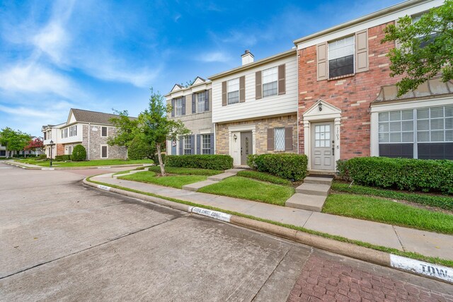2910 Grants Lake Blvd Unit 1702, Sugar Land, TX 77479 - multi unit property featuring a residential view, brick siding, and a chimney
