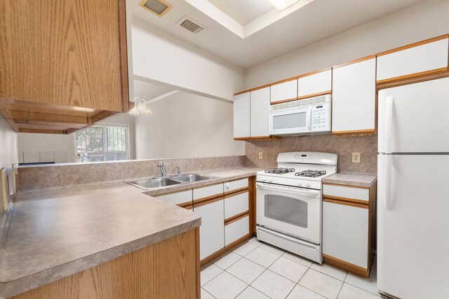 2910 Grants Lake Blvd Unit 1702, Sugar Land, TX 77479 - kitchen with white appliances, white cabinetry, light tile patterned floors, light countertops, and decorative backsplash