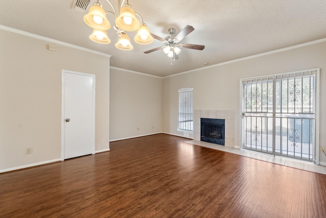 2910 Grants Lake Blvd Unit 1702, Sugar Land, TX 77479 - unfurnished living room featuring wood finished floors, a chandelier, crown molding, a tile fireplace, and a ceiling fan
