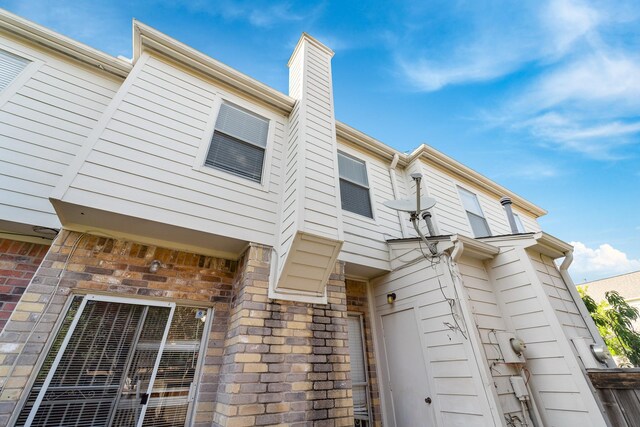2910 Grants Lake Blvd Unit 1702, Sugar Land, TX 77479 - rear view of house with a chimney