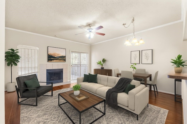 2910 Grants Lake Blvd Unit 1702, Sugar Land, TX 77479 - living area with crown molding, a ceiling fan, a textured ceiling, wood finished floors, and a fireplace