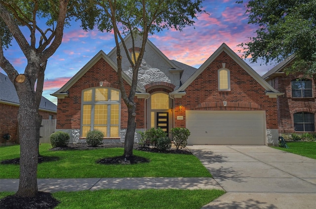 3910 Jade Cove Ln, Sugar Land, TX 77479 - view of front of home featuring stone siding, concrete driveway, brick siding, and a garage