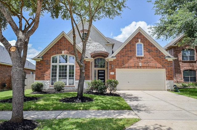3910 Jade Cove Ln, Sugar Land, TX 77479 - view of front of house with stone siding, concrete driveway, brick siding, and an attached garage