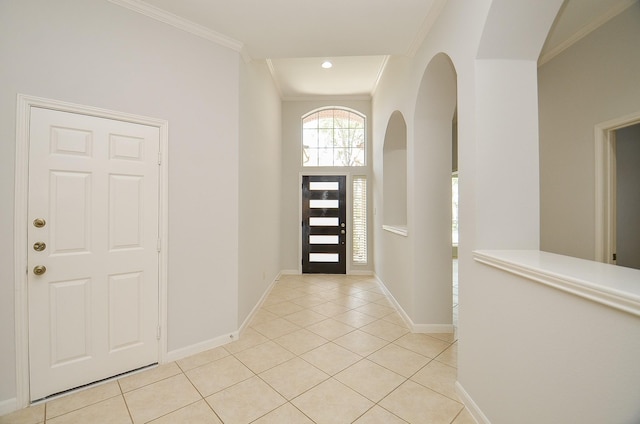 3910 Jade Cove Ln, Sugar Land, TX 77479 - foyer entrance with ornamental molding, light tile patterned flooring, arched walkways, and recessed lighting