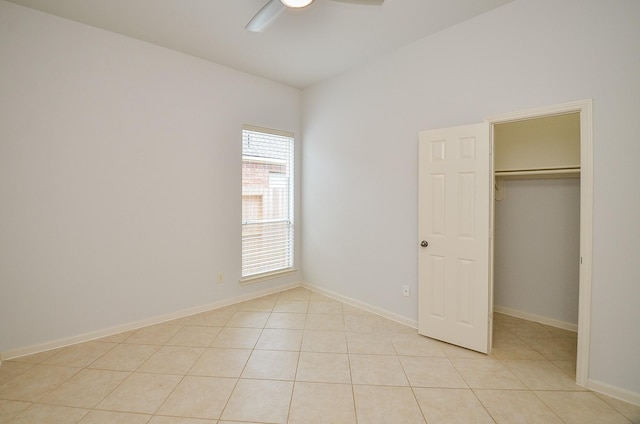 3910 Jade Cove Ln, Sugar Land, TX 77479 - unfurnished bedroom featuring light tile patterned flooring, a walk in closet, ceiling fan, and a closet