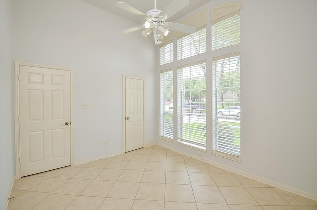 3910 Jade Cove Ln, Sugar Land, TX 77479 - spare room with a high ceiling, light tile patterned floors, and a ceiling fan