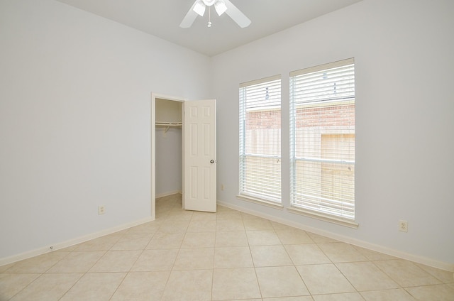 3910 Jade Cove Ln, Sugar Land, TX 77479 - unfurnished bedroom featuring a walk in closet, ceiling fan, a closet, and light tile patterned floors