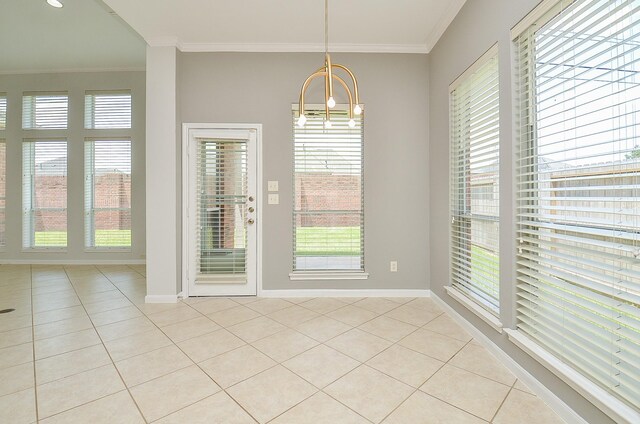 3910 Jade Cove Ln, Sugar Land, TX 77479 - unfurnished dining area featuring light tile patterned flooring, ornamental molding, and a chandelier