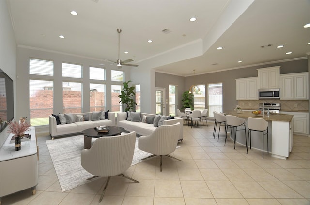 3910 Jade Cove Ln, Sugar Land, TX 77479 - living area featuring ornamental molding, ceiling fan, light tile patterned flooring, and recessed lighting
