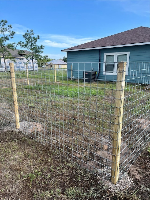 1012 Rd 5606, Cleveland, TX 77327 - view of property exterior with a central air condition unit and a shingled roof