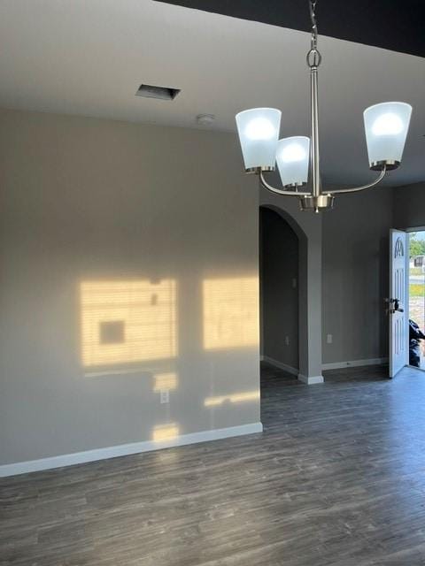1012 Rd 5606, Cleveland, TX 77327 - spare room featuring dark wood finished floors, a chandelier, and arched walkways