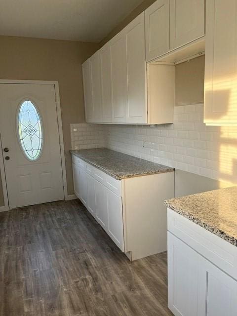 1012 Rd 5606, Cleveland, TX 77327 - kitchen with dark wood-style floors, backsplash, light stone counters, and white cabinets