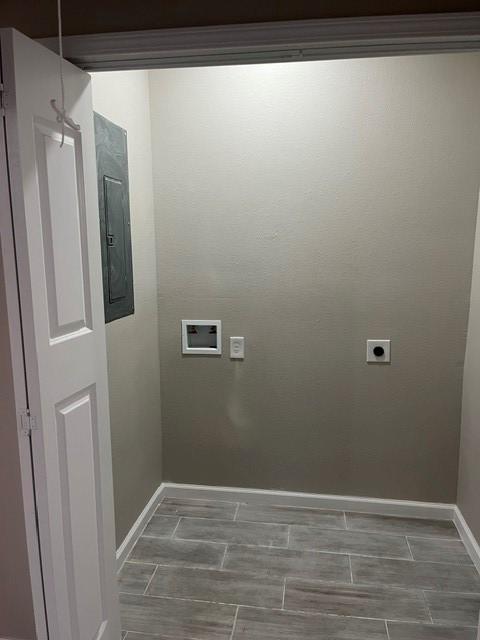 1012 Rd 5606, Cleveland, TX 77327 - laundry room featuring electric panel, electric dryer hookup, washer hookup, and wood finish floors