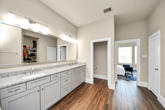 31201 Redwood Manor Ct, Spring, TX 77386 - ensuite bathroom with double vanity, wood finished floors, and a walk in closet