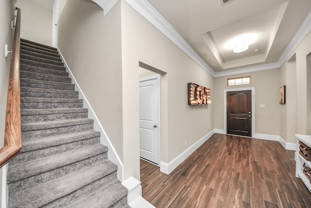 31201 Redwood Manor Ct, Spring, TX 77386 - entryway featuring stairs, dark wood-style flooring, a raised ceiling, and crown molding
