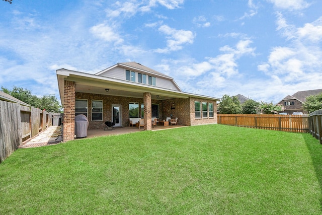 31201 Redwood Manor Ct, Spring, TX 77386 - rear view of property featuring a patio, a fenced backyard, brick siding, and an outdoor living space