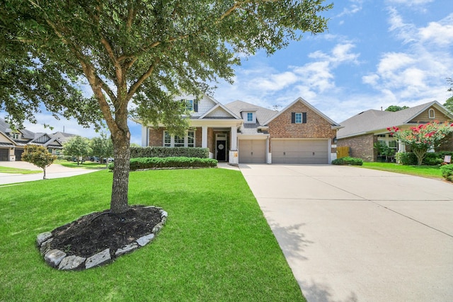 31201 Redwood Manor Ct, Spring, TX 77386 - craftsman house with concrete driveway, a front yard, brick siding, and an attached garage