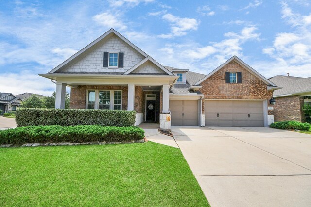 31201 Redwood Manor Ct, Spring, TX 77386 - craftsman house featuring brick siding, a front yard, a garage, and driveway