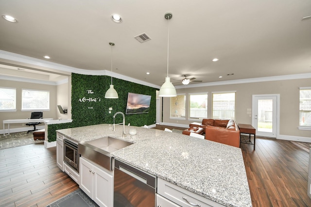 31201 Redwood Manor Ct, Spring, TX 77386 - kitchen featuring stainless steel appliances, crown molding, open floor plan, dark wood finished floors, and white cabinets