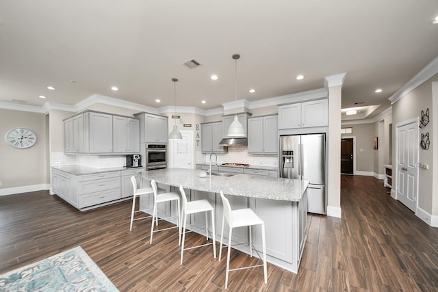 31201 Redwood Manor Ct, Spring, TX 77386 - kitchen with appliances with stainless steel finishes, gray cabinets, tasteful backsplash, ornamental molding, and light stone counters