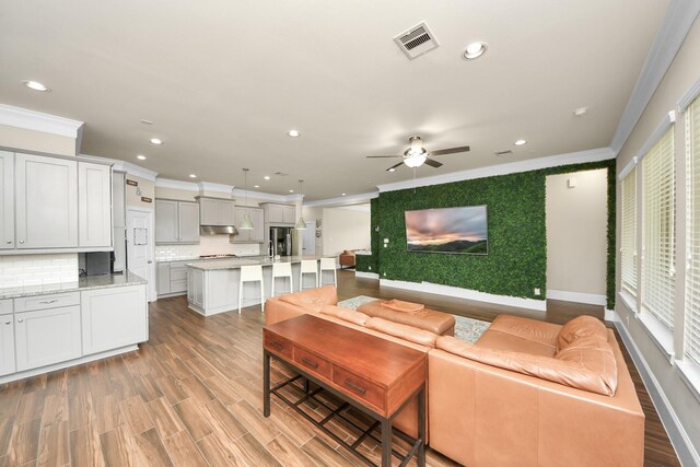 31201 Redwood Manor Ct, Spring, TX 77386 - living room featuring crown molding, recessed lighting, a ceiling fan, and light wood finished floors