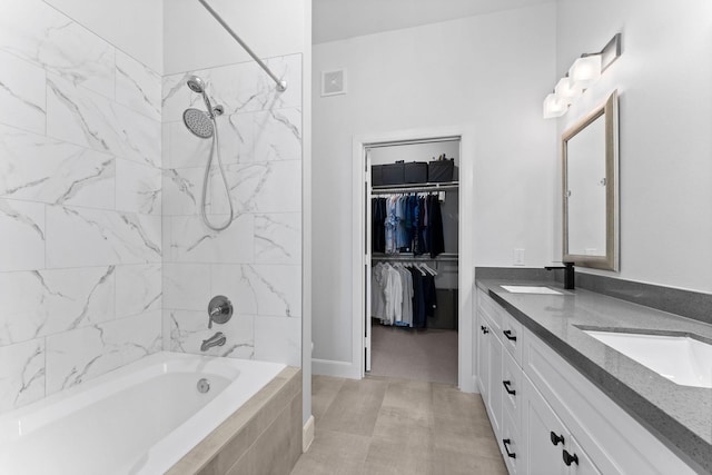 300 St Joseph Pkwy Unit 319, Houston, TX 77002 - full bathroom with double vanity, tiled shower / bath combo, and a spacious closet