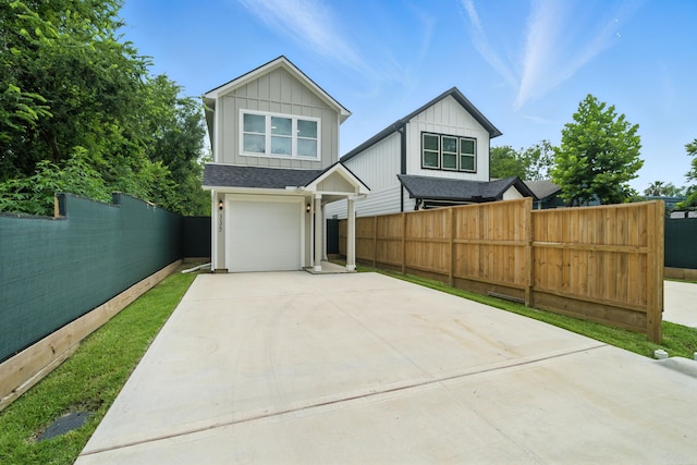 335 Todd St, Tomball, TX 77375 - view of front of house featuring driveway, board and batten siding, an attached garage, and roof with shingles