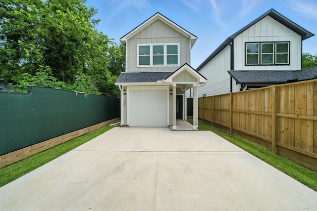 335 Todd St, Tomball, TX 77375 - view of front facade featuring concrete driveway, a garage, board and batten siding, and roof with shingles