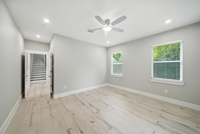 335 Todd St, Tomball, TX 77375 - empty room featuring light wood finished floors, a ceiling fan, recessed lighting, stairway, and a smoke detector