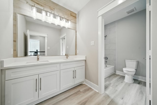 335 Todd St, Tomball, TX 77375 - full bath with double vanity, wood finished floors, and shower / tub combination