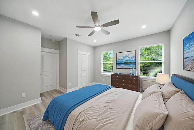 335 Todd St, Tomball, TX 77375 - bedroom featuring light wood-style flooring, ceiling fan, recessed lighting, and radiator heating unit
