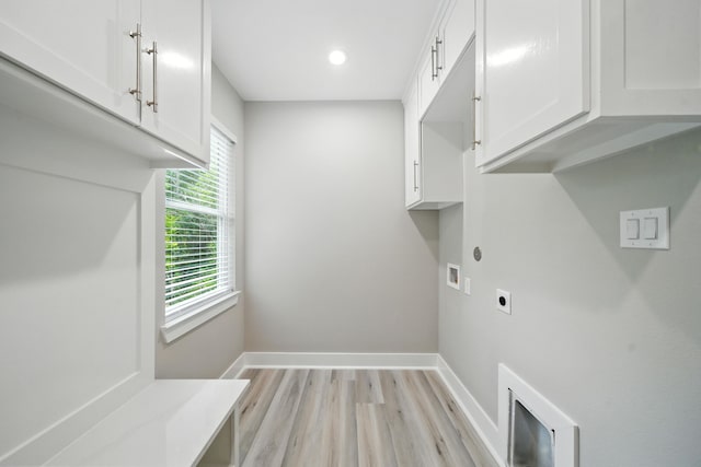 335 Todd St, Tomball, TX 77375 - washroom with electric dryer hookup, washer hookup, light wood-style flooring, recessed lighting, and cabinet space