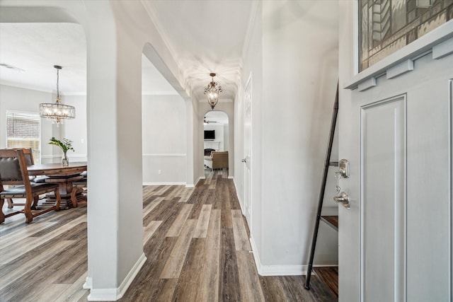 17227 Horsetooth Canyon Dr, Houston, TX 77095 - corridor featuring arched walkways, a chandelier, crown molding, and wood finished floors