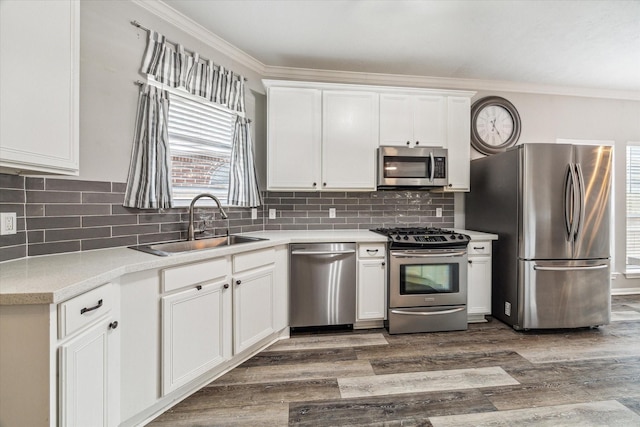 17227 Horsetooth Canyon Dr, Houston, TX 77095 - kitchen featuring appliances with stainless steel finishes, white cabinets, light countertops, tasteful backsplash, and ornamental molding