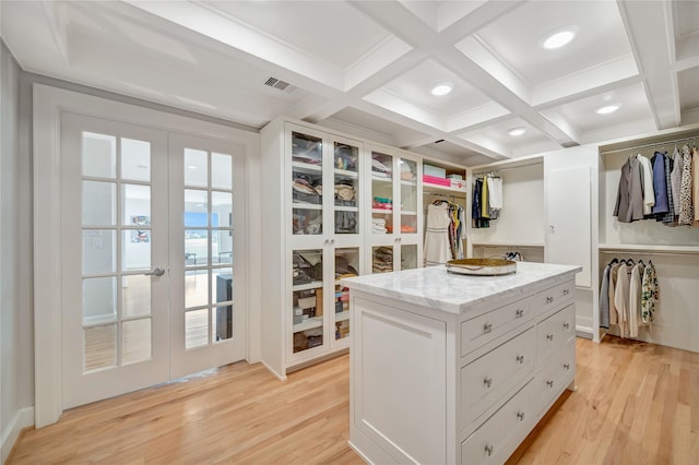 1303 Outrigger, Tiki Island, TX 77554 - spacious closet with french doors, light wood-style flooring, beamed ceiling, and coffered ceiling
