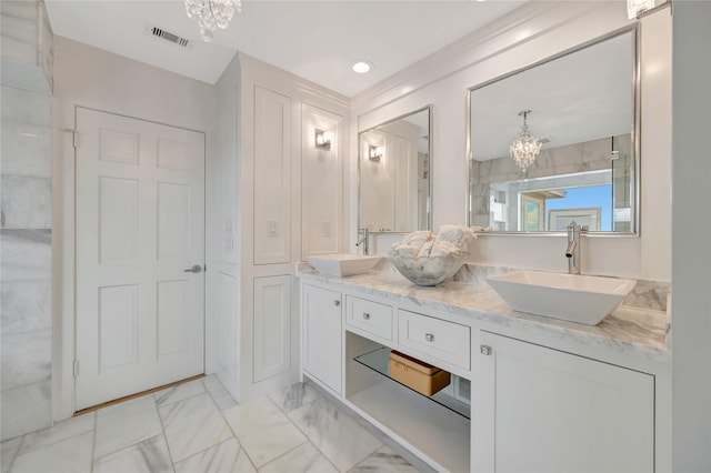 1303 Outrigger, Tiki Island, TX 77554 - bathroom with a chandelier, double vanity, and marble look tiles