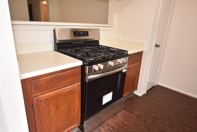 16702 Vista Oak Dr, Houston, TX 77073 - kitchen with gas stove, dark wood-style floors, brown cabinets, and light countertops