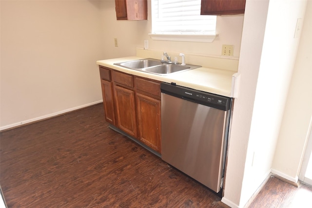 16702 Vista Oak Dr, Houston, TX 77073 - kitchen with stainless steel dishwasher, dark wood-style floors, light countertops, and brown cabinets