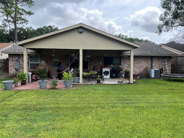 8823 Shadow Crest St, Houston, TX 77074 - rear view of property featuring a patio, brick siding, a trampoline, and a shingled roof