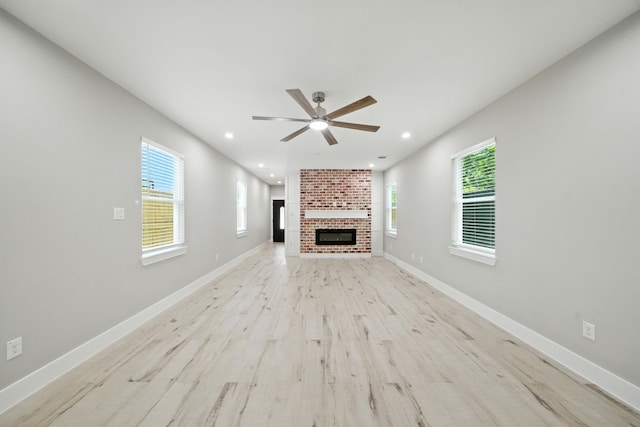 337 Todd St, Tomball, TX 77375 - unfurnished living room with ceiling fan, light wood-style floors, a brick fireplace, and recessed lighting