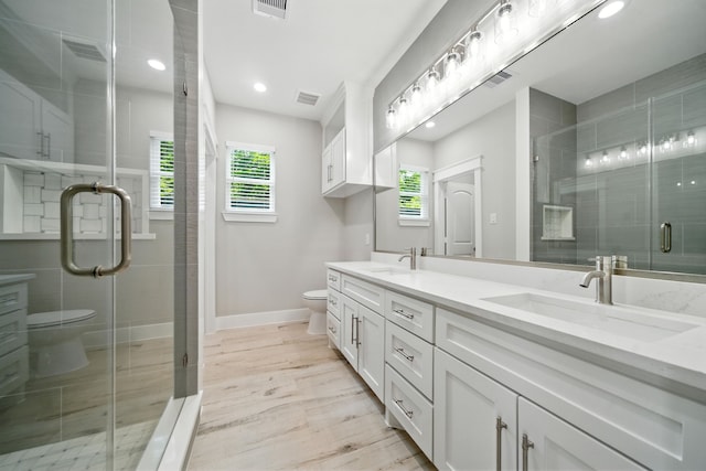 337 Todd St, Tomball, TX 77375 - full bathroom featuring double vanity, a stall shower, recessed lighting, and wood finished floors