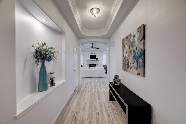 10531 Oleander Point Dr, Houston, TX 77095 - corridor with light wood-type flooring, crown molding, a tray ceiling, ornate columns, and arched walkways