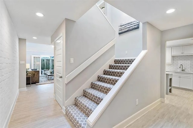 3406 Yoakum Blvd, Houston, TX 77006 - staircase with wood finished floors and recessed lighting