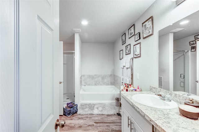 4338 Tulip Oak Dr, Houston, TX 77068 - full bathroom with a stall shower, vanity, wood finished floors, and a bath