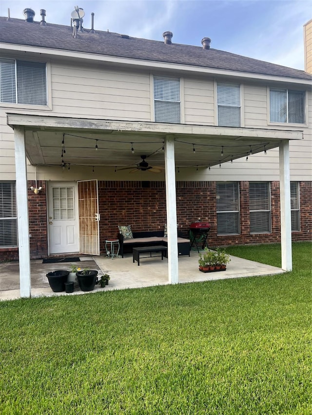 15415 Longhorn Cavern Dr, Sugar Land, TX 77498 - back of property with ceiling fan, a patio area, brick siding, a yard, and an outdoor living space