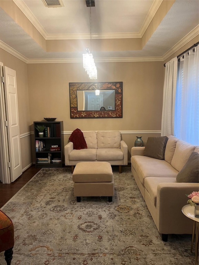 15415 Longhorn Cavern Dr, Sugar Land, TX 77498 - living area featuring a tray ceiling, wood finished floors, ornamental molding, and a chandelier