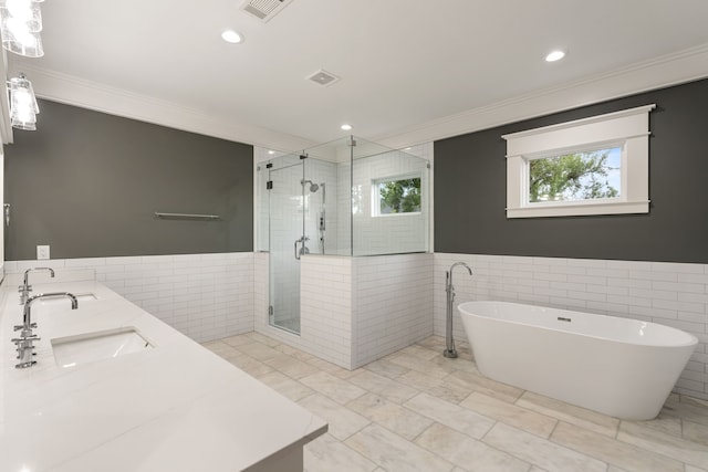 1114 Grovewood Ln, Houston, TX 77008 - full bath with ornamental molding, tile walls, a shower stall, a soaking tub, and double vanity